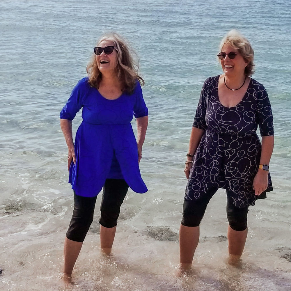 two women laughing in ocean